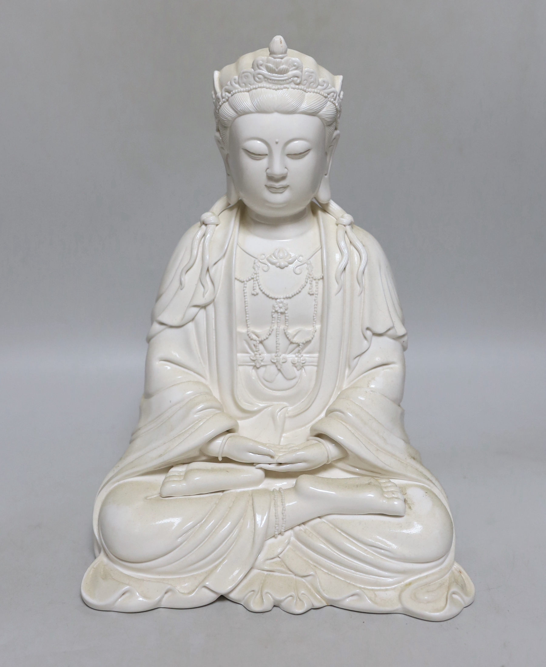 A Chinese blanc de chine seated figure of Guanyin, 29cm high